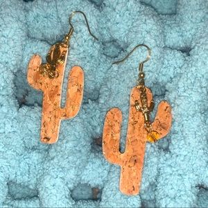 This is a handmade pair of leather cactus cutout earrings